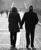 man-and-woman-walking-on-sidewalk-3638157