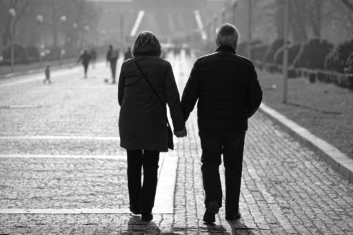 man-and-woman-walking-on-sidewalk-3638157